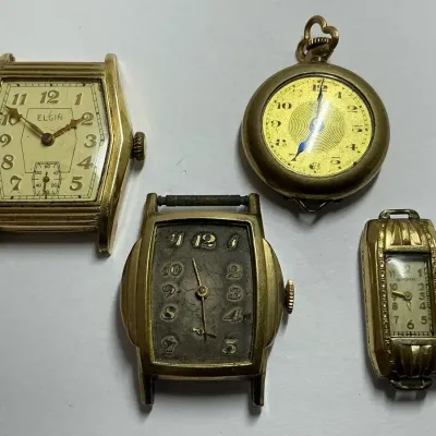 Four Gold Tone Watch Faces 
