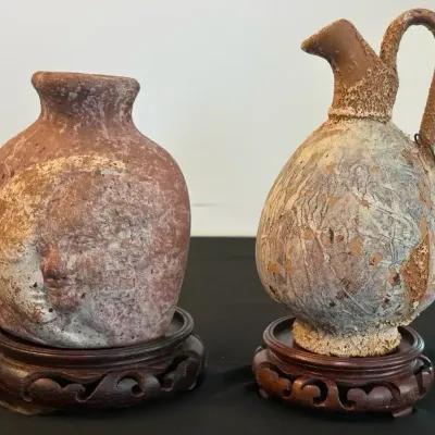 Pair of Decorative Ceramic Vessels on Carved Wooden Stands