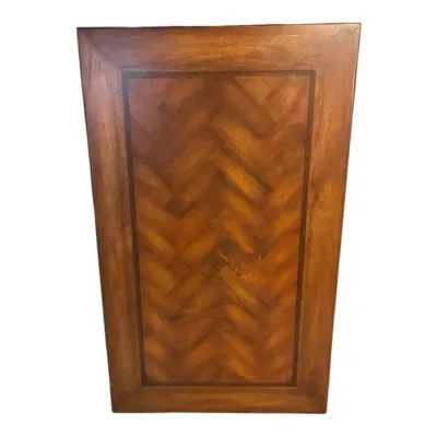 Wooden table top features a classic herringbone veneer pattern framed by a darker contrasting wood b