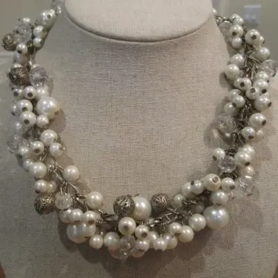 Sale Photo Thumbnail #226: Beautiful white faux pearl cha cha necklace with silver tone filigree beads on a silver tone adjustable chain. Good Condition.
Choker size 16"