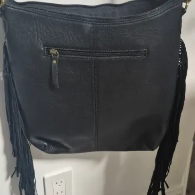 Sale Photo Thumbnail #11: Tumbleweed trail fringed had tooled Crossbody bag by MYRA BAG
Myra Hand Tooled leather Handbag Features
Premium Hairon Leather

Classy Handtooled Pattern

Convenient Phone Compartment

Zipper-close top

Trendy Fringe Accents

Myra Tooled Handbags Dimensio