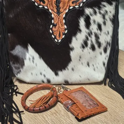 Sale Photo Thumbnail #5: Tumbleweed trail fringed had tooled Crossbody bag by MYRA BAG
Myra Hand Tooled leather Handbag Features
Premium Hairon Leather

Classy Handtooled Pattern

Convenient Phone Compartment

Zipper-close top

Trendy Fringe Accents

Myra Tooled Handbags Dimensio