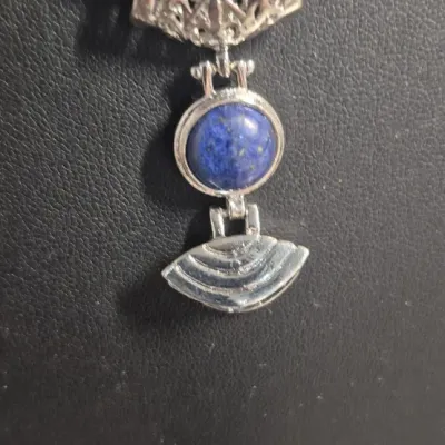 Sale Photo Thumbnail #30: Lapis Lazuli Pendant 925 sterling snake chain & Dangle Earrings
Necklace is 16" w/ lobster claw, Pendant has filigree scroll bail.
Pendant has a Deco design