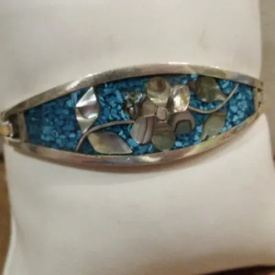 Sale Photo Thumbnail #235: Alpaca Mexico silver with turquoise and mother of pearl inlay flower designer bangle bracelet - signed.
excellent condition