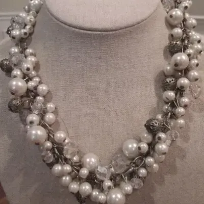 Sale Photo Thumbnail #229: Beautiful white faux pearl cha cha necklace with silver tone filigree beads on a silver tone adjustable chain. Good Condition.
Choker size 16"