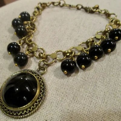 Vintage Bracelet Black Glass Cabochons w/dangling black beads Brass Tone Chain