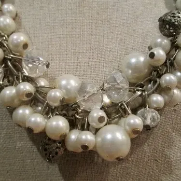 Sale Photo Thumbnail #227: Beautiful white faux pearl cha cha necklace with silver tone filigree beads on a silver tone adjustable chain. Good Condition.
Choker size 16"