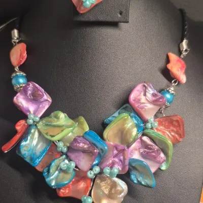 Sale Photo Thumbnail #13: Shell flower Necklace, leather and freshwater pearls. & Matching Bracelet
Necklace is 16" with leather braided and lobster claw closure
Bracelet has leather with button closure
Both excellent condition......found as New 
All is wire tied and secure