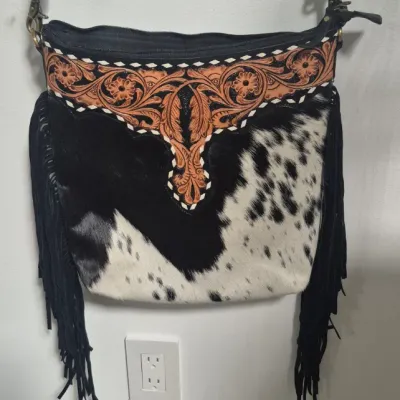 Sale Photo Thumbnail #8: Tumbleweed trail fringed had tooled Crossbody bag by MYRA BAG
Myra Hand Tooled leather Handbag Features
Premium Hairon Leather

Classy Handtooled Pattern

Convenient Phone Compartment

Zipper-close top

Trendy Fringe Accents

Myra Tooled Handbags Dimensio