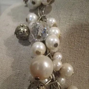 Sale Photo Thumbnail #228: Beautiful white faux pearl cha cha necklace with silver tone filigree beads on a silver tone adjustable chain. Good Condition.
Choker size 16"