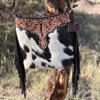 Sale Photo Thumbnail #4: Tumbleweed trail fringed had tooled Crossbody bag by MYRA BAG
Myra Hand Tooled leather Handbag Features
Premium Hairon Leather

Classy Handtooled Pattern

Convenient Phone Compartment

Zipper-close top

Trendy Fringe Accents

Myra Tooled Handbags Dimensio