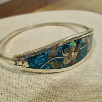 Sale Photo Thumbnail #234: Alpaca Mexico silver with turquoise and mother of pearl inlay flower designer bangle bracelet - signed.
excellent condition