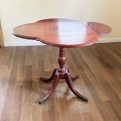 LOT 64: Wooden 4-Sided Drop Cloverleaf Pedestal Table, Floor Lamp and Floral Wall Art