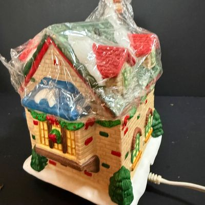 LOT 24: Holiday Novels by Mary Higgens Clark and John Grisham, Nativity Set In Original Box, Metal Church Candle Holder and More