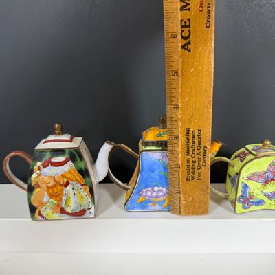 LOT 75: Collection of Miniature Enamel Teapots by Kelvin Chen, Mini Glass Flower Teapot Paperweights, Lenox Shell Shaped Dish & More