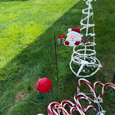 LOT 63: Assortment of Christmas Lawn Decorations Including Rope Light Christmas Trees, Candy Cane Lights. Snowflake Wind Spinner, Red...