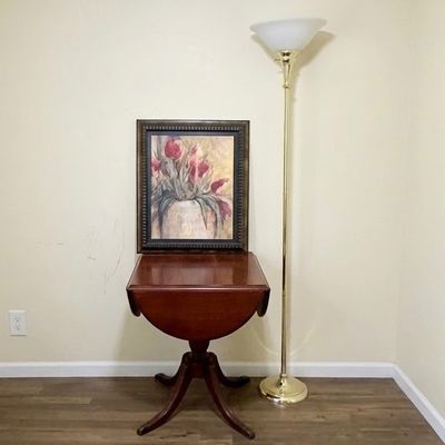 LOT 64: Wooden 4-Sided Drop Cloverleaf Pedestal Table, Floor Lamp and Floral Wall Art