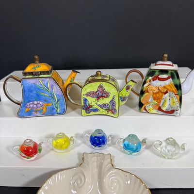 LOT 75: Collection of Miniature Enamel Teapots by Kelvin Chen, Mini Glass Flower Teapot Paperweights, Lenox Shell Shaped Dish & More