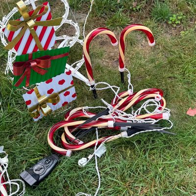 LOT 63: Assortment of Christmas Lawn Decorations Including Rope Light Christmas Trees, Candy Cane Lights. Snowflake Wind Spinner, Red...