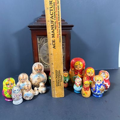 LOT: 72: Collection of Russian Style Nesting Dolls and Quartz Bombay Co Mantle Clock