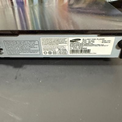 LOT 73: Samsung Blu-Ray Player BD-EM59C with a Large Selection of DVDs and 2 Blu-Rays - Including Unopened DVDs