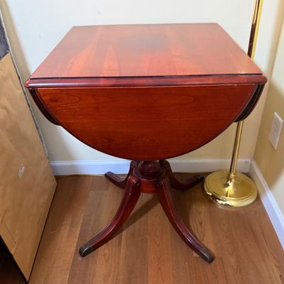 LOT 64: Wooden 4-Sided Drop Cloverleaf Pedestal Table, Floor Lamp and Floral Wall Art