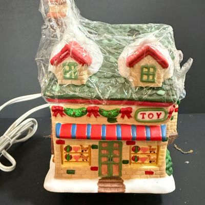 LOT 24: Holiday Novels by Mary Higgens Clark and John Grisham, Nativity Set In Original Box, Metal Church Candle Holder and More