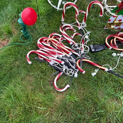 LOT 63: Assortment of Christmas Lawn Decorations Including Rope Light Christmas Trees, Candy Cane Lights. Snowflake Wind Spinner, Red...