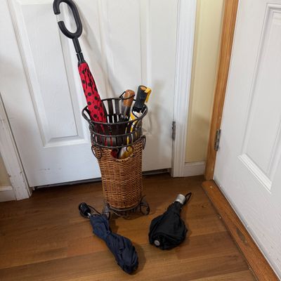 LOT 163: Metal and Wicker Umbrella Stand with Umbrellas
