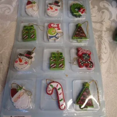 Sale Photo Thumbnail #34: 3 Furies ornaments, 1 wreath, 1 envelope/wrapping paper cutter, truck pick, 3 bead clips wreath hanger, 2  egg nativity ornaments, set of 12 miniature ornaments, Santa hat size Medium, 2 doves with a poem in a burlap bag, 1 snowflake,  see pictures