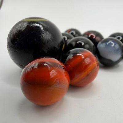 Sale Photo Thumbnail #1159: Black Base Cats Eye Glass Marble Collection with Player and Shooter Marbles