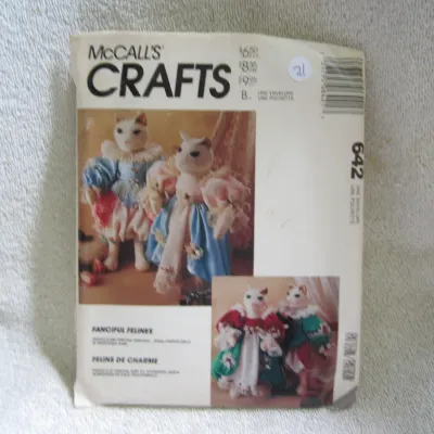 Sale Photo Thumbnail #22: Vintage McCall's Crafts sewing pattern number 642 for 'Fanciful Felines' stuffed cat dolls in traditional costumes. The envelope shows some light wear and creasing consistent with age, including a small retail sticker on the front. Pattern appears to be u