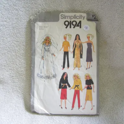 Sale Photo Thumbnail #31: Vintage Simplicity sewing pattern number 9194, designed for 11 1/2-inch fashion dolls such as Barbie. Includes patterns for a bridal gown, jumpsuit, dresses, pants, and wrap jackets. The envelope shows visible wear, creasing, and minor tears along the edg
