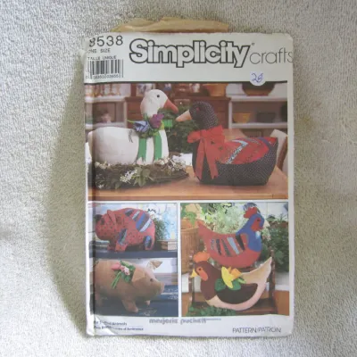 Sale Photo Thumbnail #29: Vintage Simplicity Crafts sewing pattern 8538 designed by Marjorie Puckett. Features patterns and instructions for making soft stuffed animals including geese, pigs, and hens. One size. The envelope shows some wear, creasing, and minor tearing at the top 
