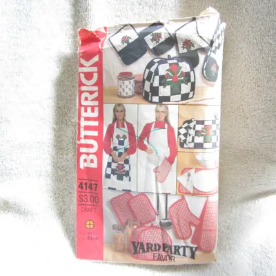 Sale Photo Thumbnail #34: Vintage Butterick craft sewing pattern number 4147, titled 'Yard Party Favor'. This pattern includes templates and instructions for various kitchen and dining accessories, including aprons, oven mitts, appliance covers, placemats, and pot holders. The env