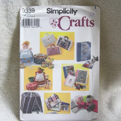 Sale Photo Thumbnail #54: Simplicity Crafts sewing pattern number 9339. One size. Includes patterns for various home and personal craft items such as decorative dolls, fabric bags, book covers, a sewing machine cover, and computer desk accessories. The envelope shows minor wear fr