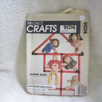 Sale Photo Thumbnail #14: Vintage McCall's Crafts sewing pattern number 9074 for "Blossom Babies" soft-sculptured dolls designed by Faye Wine. Features patterns to make Jonny Jumpup, Baby Bud, Amaryllis, Marigold, and Busy Lizzie. The envelope shows some light wear and creasing co