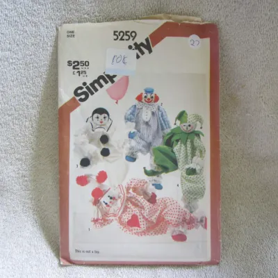 Sale Photo Thumbnail #28: Vintage Simplicity sewing pattern number 5259 for stuffed clown dolls. Features designs for four different clown styles. One size. The envelope shows some wear, creasing, and has stickers/writing on the front. Pattern pieces are unchecked for completeness