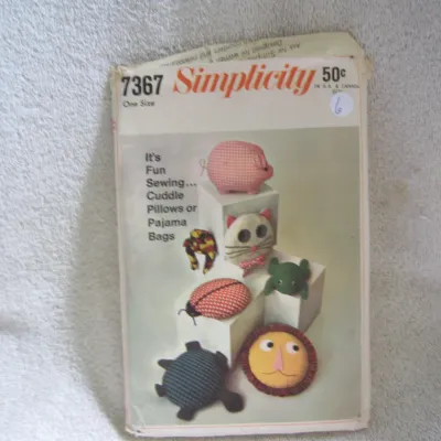 Sale Photo Thumbnail #7: Vintage Simplicity sewing pattern number 7367 for 'Cuddle Pillows or Pajama Bags'. Includes patterns to make animal-shaped pillows or pajama bags including a pig, cat, frog, ladybug, turtle, and lion. One size. The envelope shows some wear, creasing, and 