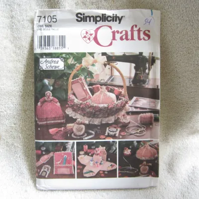 Sale Photo Thumbnail #55: Simplicity Crafts sewing pattern number 7105, designed by Andrea Schewe. Features patterns for various sewing accessories including a basket cover, pincushions, needle cases, and decorative sewing dolls. One size. Envelope shows light wear, creasing, and 