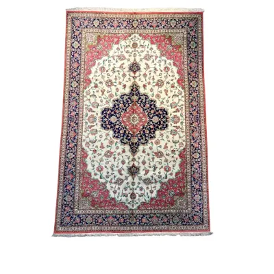 Ivory, blue, burgundy, and muted red traditional rug featuring a detailed central medallion and ornate floral border.