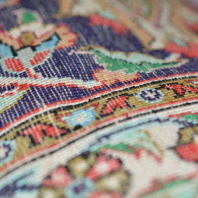 Detailed close-up showcasing colorful handwoven texture, intricate geometric motifs, and vibrant blue, red, green, ivory, and yellow...