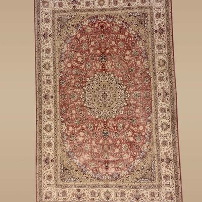 Soft rose, ivory, and muted red traditional rug featuring an intricate central medallion surrounded by delicate floral detailing.