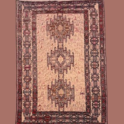 Muted rose and ivory traditional rug featuring a detailed geometric central motif and multiple decorative borders.