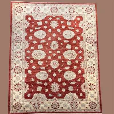 Burgundy and ivory rug featuring bold repeating floral medallions and decorative geometric detailing throughout the field and border.
