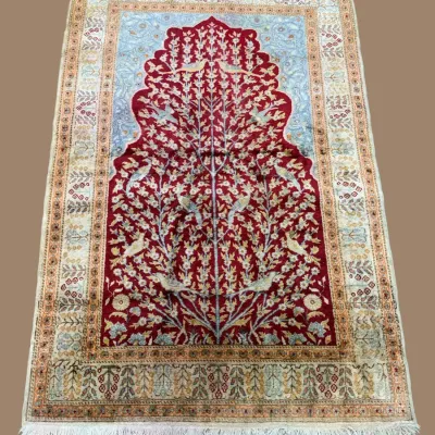 Beautiful red and ivory traditional rug featuring an intricate central medallion, detailed floral motifs, and an ornate decorative border.