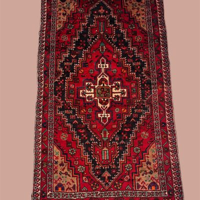 Vibrant red, black, and ivory traditional rug featuring a bold diamond-shaped central medallion surrounded by intricate geometric detailing.
