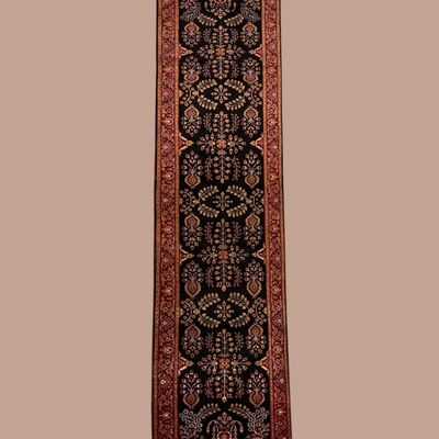 Deep red runner featuring repeating traditional geometric motifs with warm burgundy, brown, and ivory detailing.