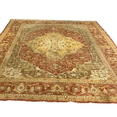 Warm gold, rust, and muted orange traditional rug featuring elegant floral detailing and a richly patterned decorative border.