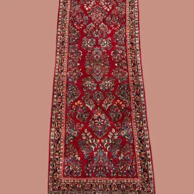 Traditional red and blue runner featuring an intricate repeating pattern and richly detailed border. A beautiful statement piece for a...